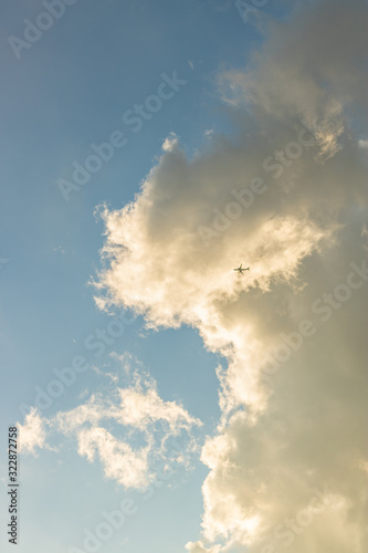 A plane flying under the clouds