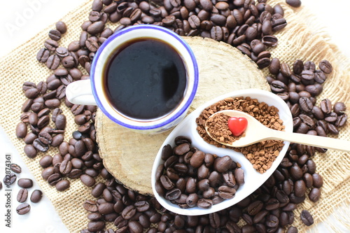 Coffee beans, accompanied by processed coffee powder