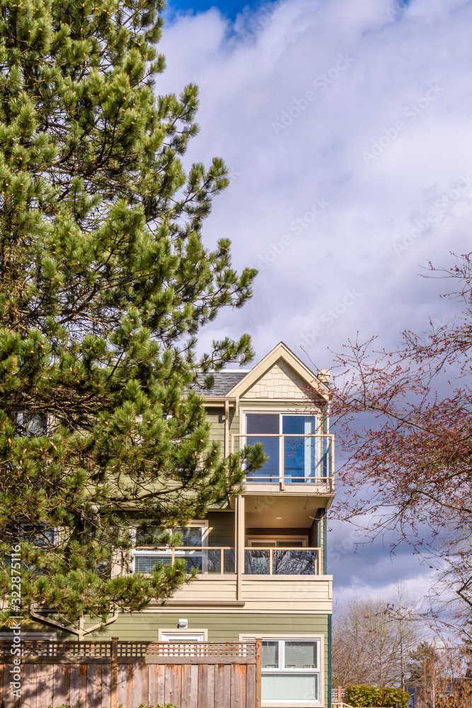 A perfect neighborhood. Houses in suburb at Summer in the north America. Top of a luxury house with nice window over blue sky.