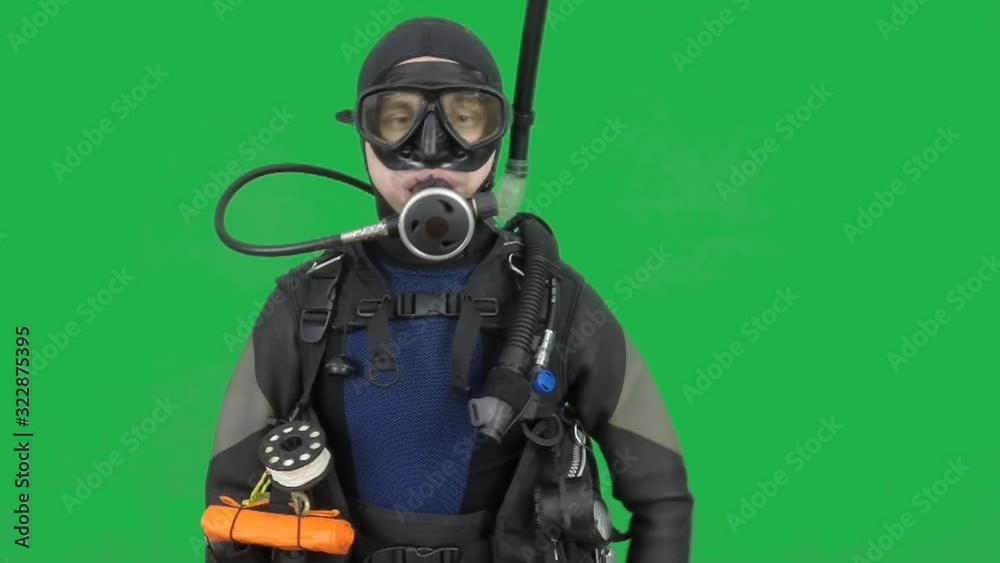 Scuba dive instructor shows signal – swim faster- on the green screen Scuba dive instructor shows signal – swim faster- on the green screen