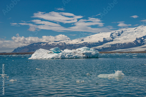 View of Glacier Lagoon Jokulsarlon with icebergs and Vatnajokull Glacier tongue, Iceland, summer