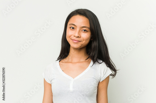 Young chinese woman posing on a white background © Asier