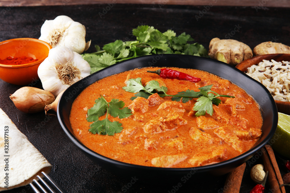 Chicken tikka masala spicy curry meat food in pot with rice and naan bread. indian food