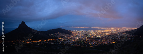Table Mountain panorama night with lions head and cape town