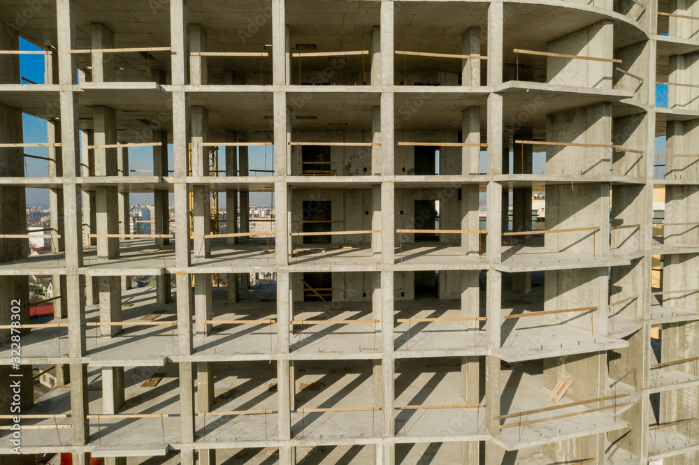 Aerial view of concrete frame of tall apartment building under construction in a city Aerial view of concrete frame of tall apartment building under construction in a city