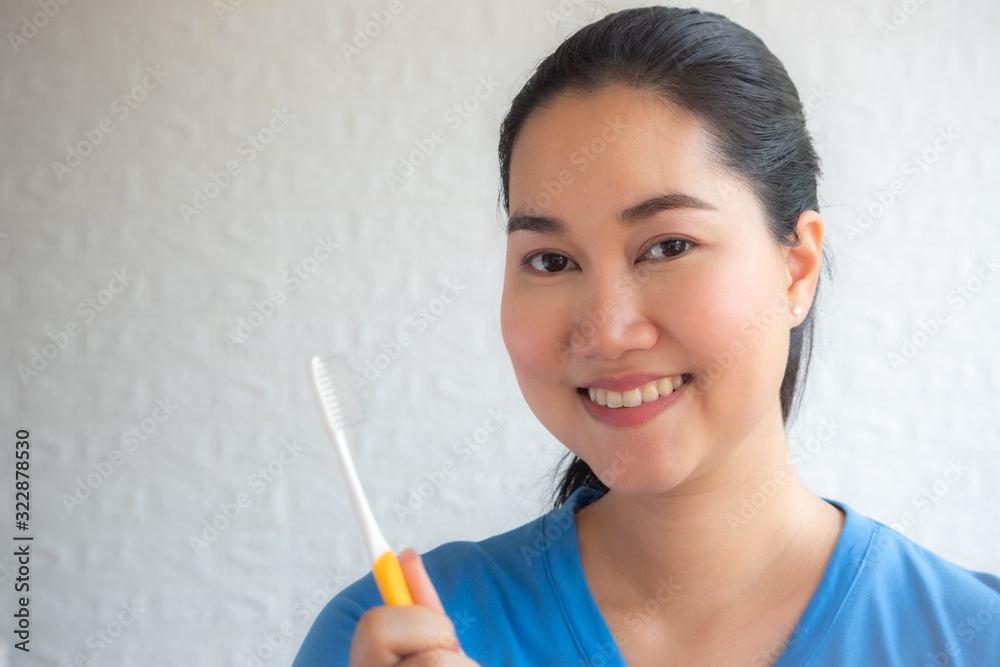 Portrait of a smiling cute woman holding toothbrush isolated on a white background,Shot of perfect teeth with toothbrush, on white background. Portrait of a smiling cute woman holding toothbrush isolated on a white background,Shot of perfect teeth with toothbrush, on white background.