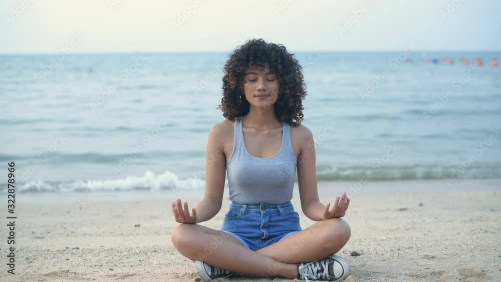 Holiday concept. Beautiful girl is practicing yoga by the beach. 4k Resolution. Holiday concept. Beautiful girl is practicing yoga by the beach. 4k Resolution.