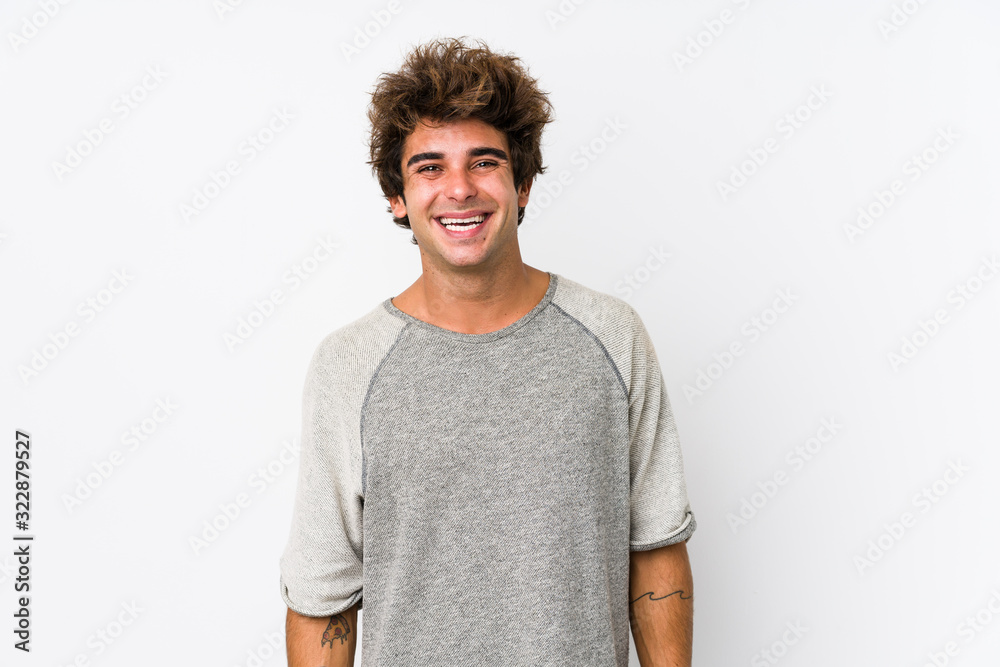 Young caucasian man against a white background isolated happy, smiling and cheerful.