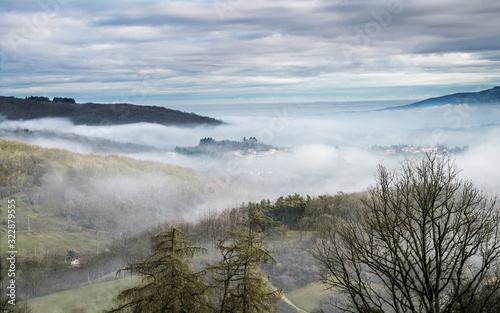 French countryside in the morning mist, winter on the valley seen from Col de la Luère, Rhône - France