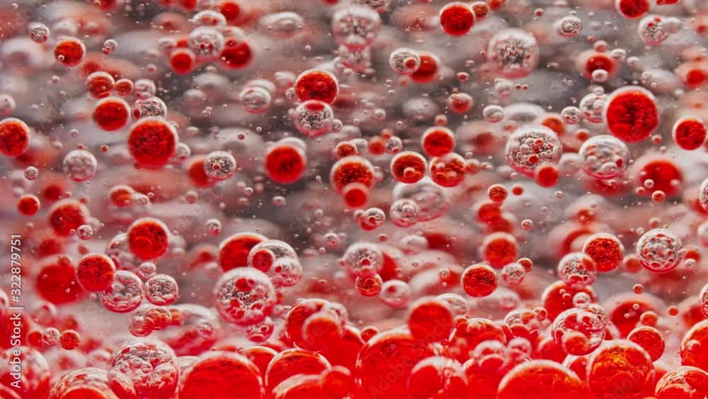 many small red bubbles floating in water, slowly sinking many small red bubbles floating in water, slowly sinking