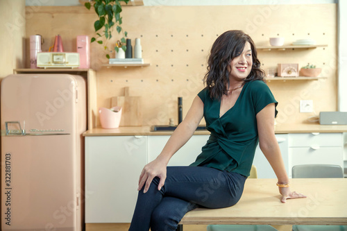 A person sitting in a kitchen looking back over shoulder., Studio City, CA, USA