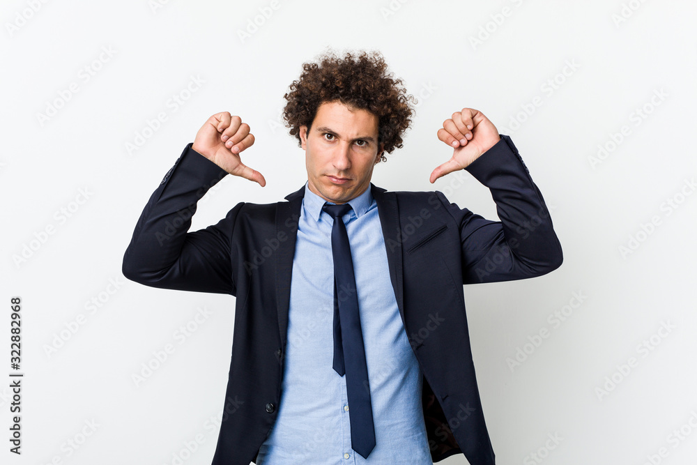 Young business curly man against white background feels proud and self confident, example to follow. Young business curly man against white background feels proud and self confident, example to follow.