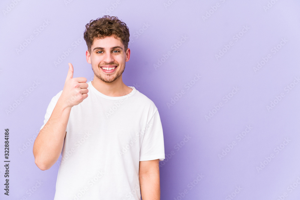 Young blond curly hair caucasian man isolated smiling and raising thumb up Young blond curly hair caucasian man isolated smiling and raising thumb up