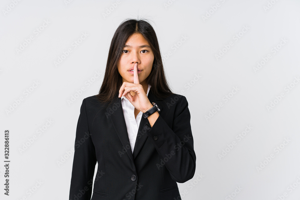 Young asian business woman keeping a secret or asking for silence. Young asian business woman keeping a secret or asking for silence.