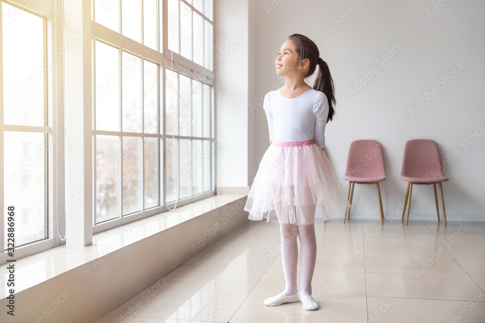 Little ballerina in dance studio