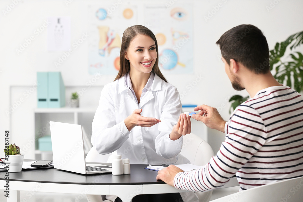 Ophthalmologist explaining patient how to use contact lenses
