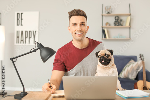 Handsome man with cute pug ...