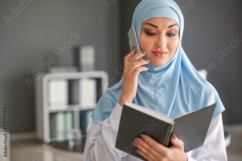 Young Arab woman talking by...