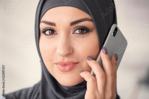 Young Arab woman talking by...
