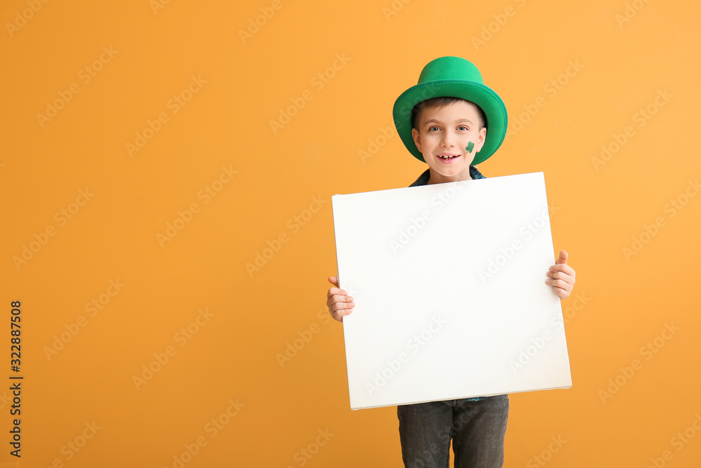Funny little boy with blank poster on color background. St. Patrick's Day celebration Funny little boy with blank poster on color background. St. Patrick's Day celebration