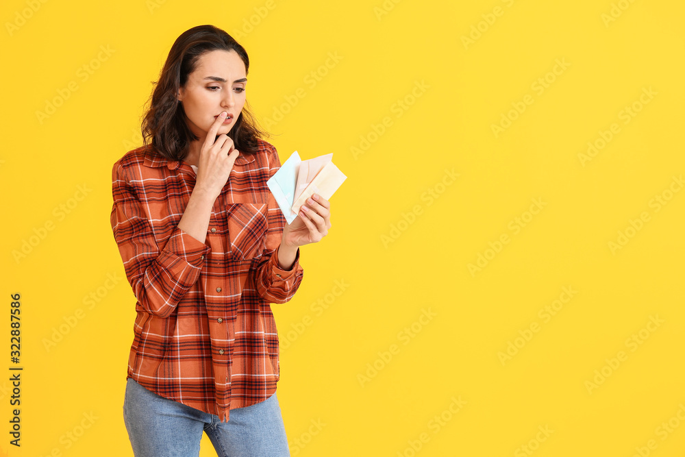 Young woman with menstrual pads on color background