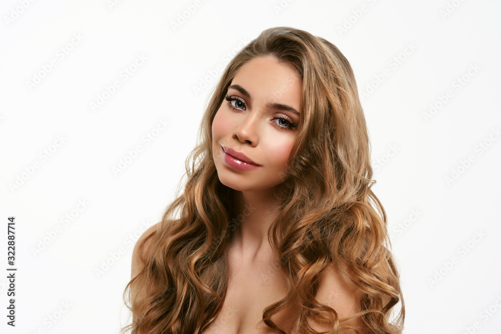 Portrait of young beautiful woman isolated at white background. Blonde girl with long and shiny wavy hair . Smiling friendly girl with curly hairstyle Portrait of young beautiful woman isolated at white background. Blonde girl with long and shiny wavy hair . Smiling friendly girl with curly hairstyle