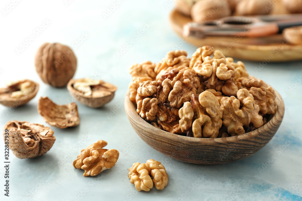 Bowl with tasty walnuts on table Bowl with tasty walnuts on table