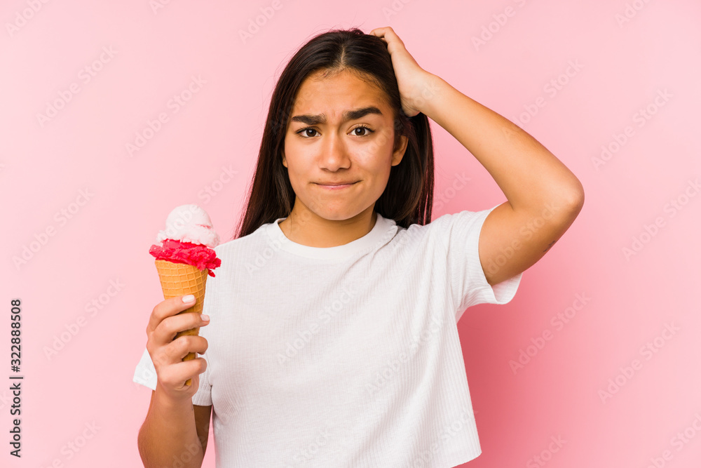 Young asian woman holding a ice cream isolated being shocked, she has remembered important meeting. Young asian woman holding a ice cream isolated being shocked, she has remembered important meeting.