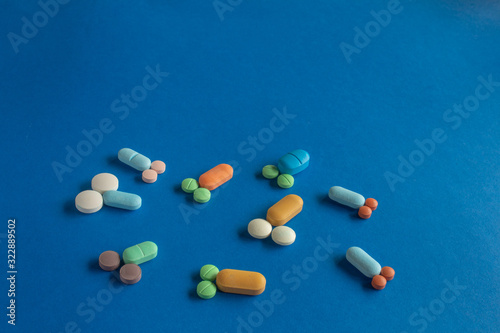 Fotografie Pills and tablets forming small penises and testicles