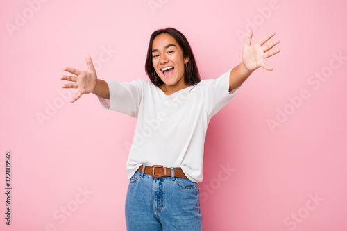 Young mixed race indian woman feels confident giving a hug to the camera.