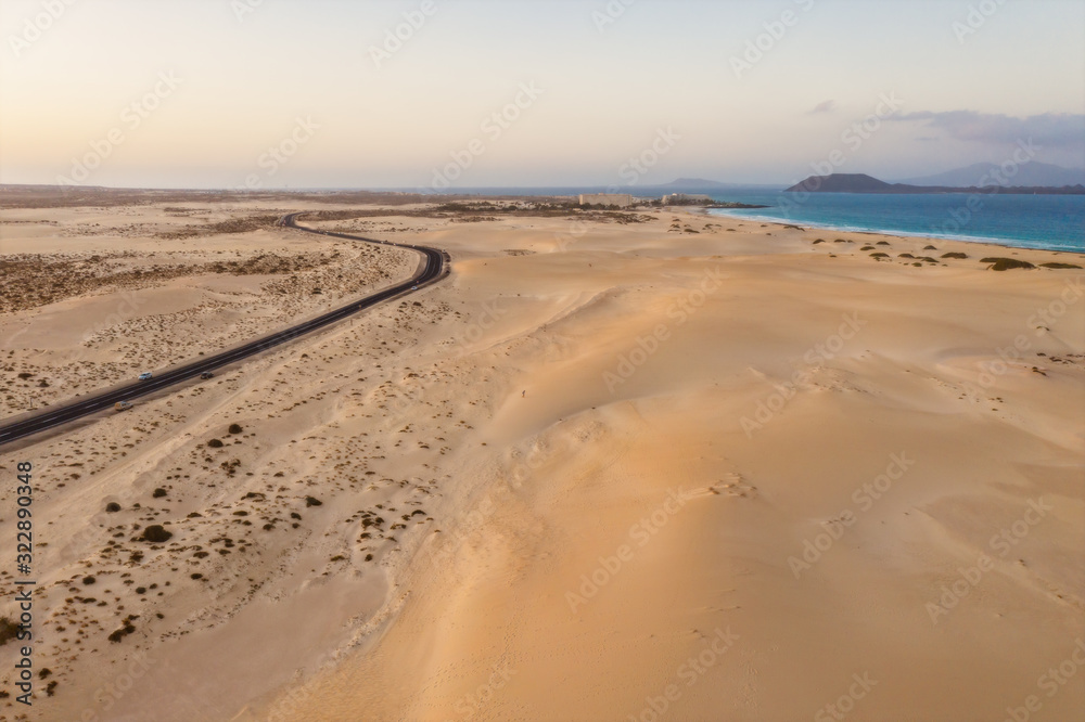 High angle view of road going through Corralejo dunes nature park in Fuerteventura. Aerial drone shot in october 2019 High angle view of road going through Corralejo dunes nature park in Fuerteventura. Aerial drone shot in october 2019