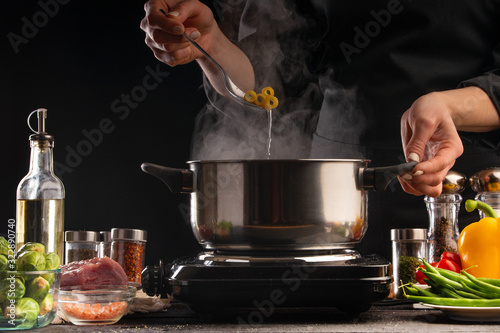 Cooking Italian pasta, sauce. Freeze on the move, vegetables and meat. On a black background, horizontal photo. Advertising, cooking, recipe book, home meals, restaurant business.