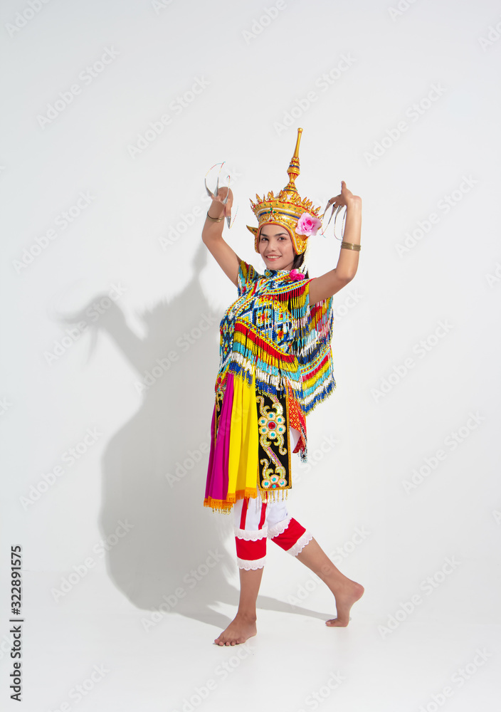 Young lady wearing Thai Tradition southern costume and headdress on her head,showing basic pattern folk dance,black shadow reflection on white background