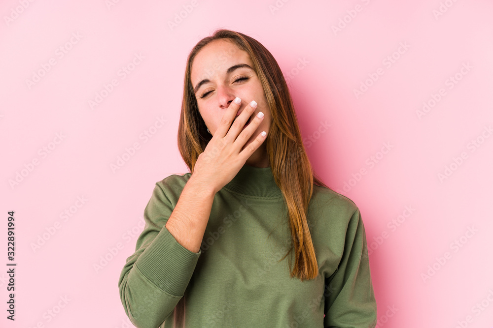 Young caucasian woman posing isolated yawning showing a tired gesture covering mouth with hand. Young caucasian woman posing isolated yawning showing a tired gesture covering mouth with hand.