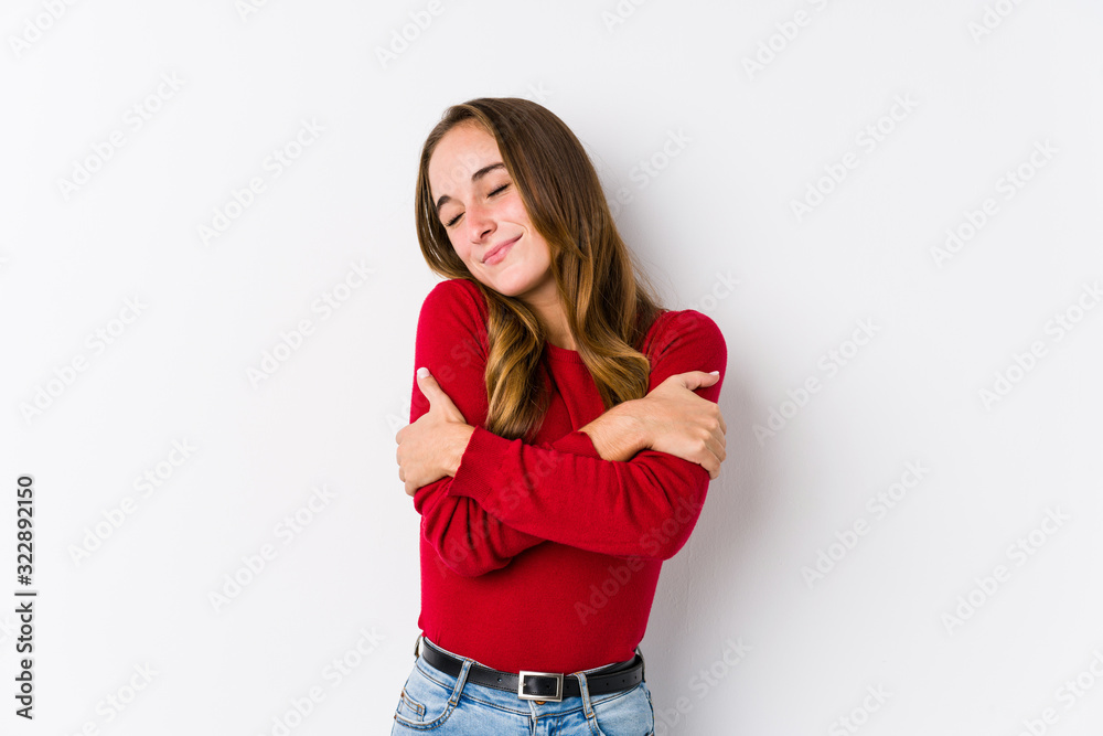 Young caucasian woman posing isolated hugs, smiling carefree and happy. Young caucasian woman posing isolated hugs, smiling carefree and happy.