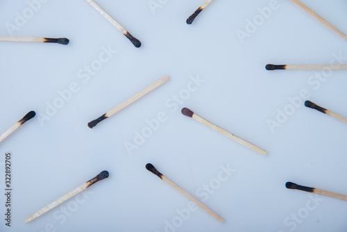 Burned matches other than one on a white background