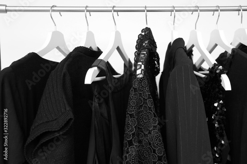 Εκτύπωση καμβά set of women's clothing in black in different colors on hangers, a concept for f