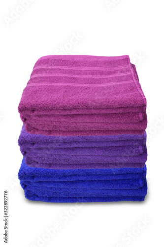 pile of clean terry bath colored towels isolated on a white background, close-up, copy space, concept of cleanliness, bath procedure, spa