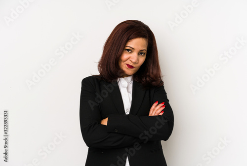 Middle age latin business woman isolated frowning face in displeasure  keeps arms folded.