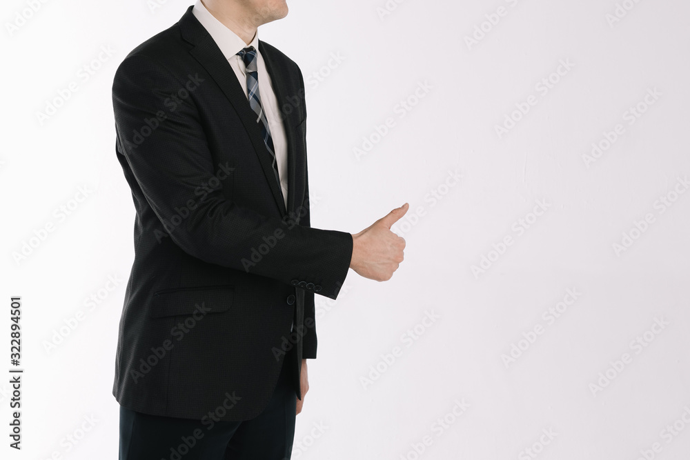portrait of a businessman standing on a white background. The hand shows the gesture a class portrait of a businessman standing on a white background. The hand shows the gesture a class