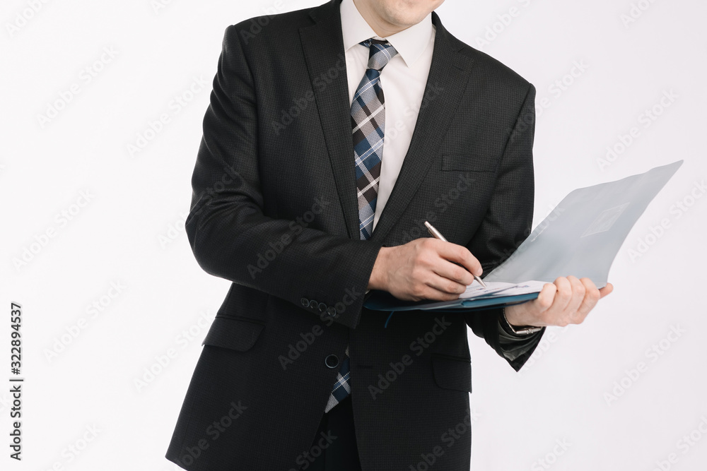business document. business man, writing on a tablet on a blank sheet. A businessman in a businessman's suit signs a document on a white background. business document. business man, writing on a tablet on a blank sheet. A businessman in a businessman's suit signs a document on a white background.