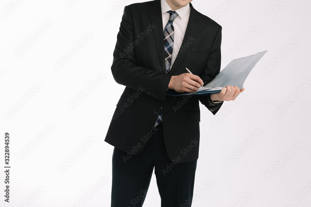 business document. business man, writing on a tablet on a blank sheet. A businessman in a businessman's suit signs a document on a white background. business document. business man, writing on a tablet on a blank sheet. A businessman in a businessman's suit signs a document on a white background.