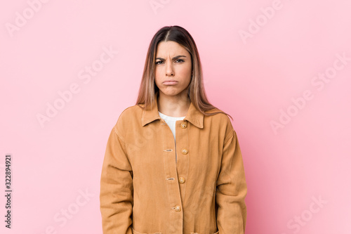 Young caucasian woman isolated blows cheeks, has tired expression. Facial expression concept. © Asier