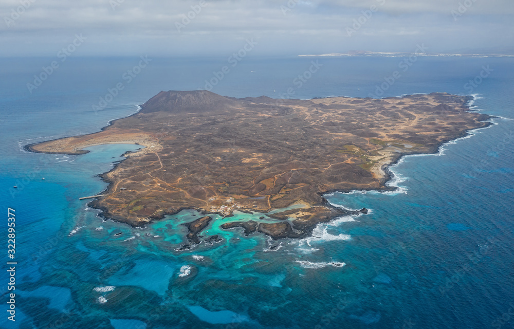 Stunning high angle panoramic aerial drone view of Isla de Lobos, a small uninhabited island just 2 kilometres off the coast of Fuerteventura, Canary Islands, Spain. October 2019