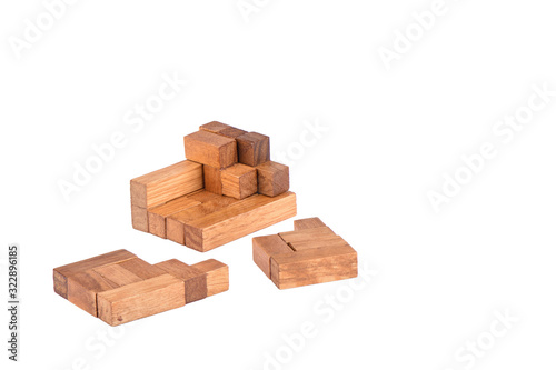 Three-dimensional wooden pentamino board game on a white background.