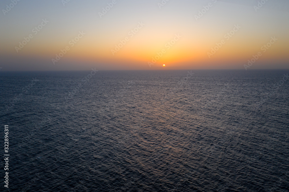 Sunset over ocean from Ajuy beach, Fuerteventura - Canary islands. Aerial drone view in october 2019