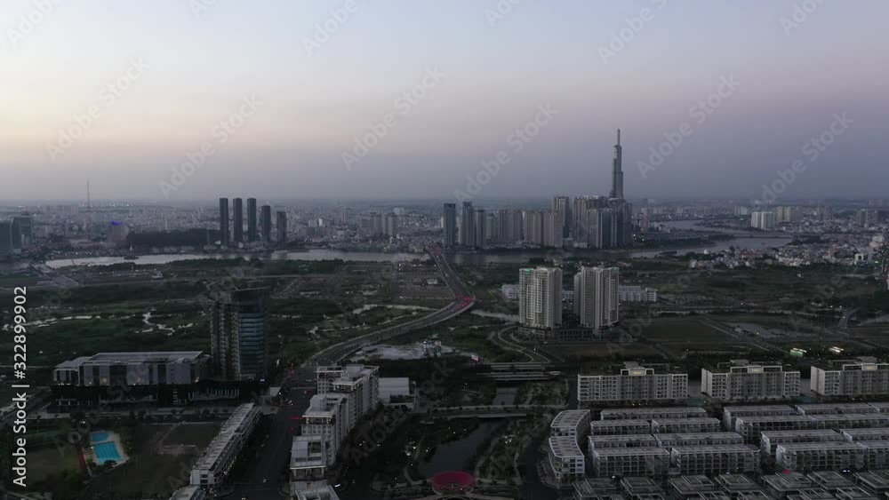Aerial panning shot to the right of Saigon river featuring new developments in district two and Binh Thanh in Ho Chi Minh City, Vietnam at twilight. Aerial panning shot to the right of Saigon river featuring new developments in district two and Binh Thanh in Ho Chi Minh City, Vietnam at twilight.