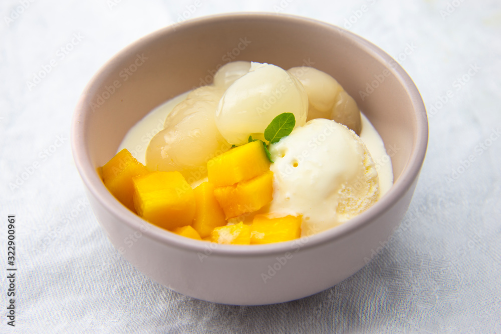Garnished lychee and mango with vanilla ice cream Garnished lychee and mango with vanilla ice cream