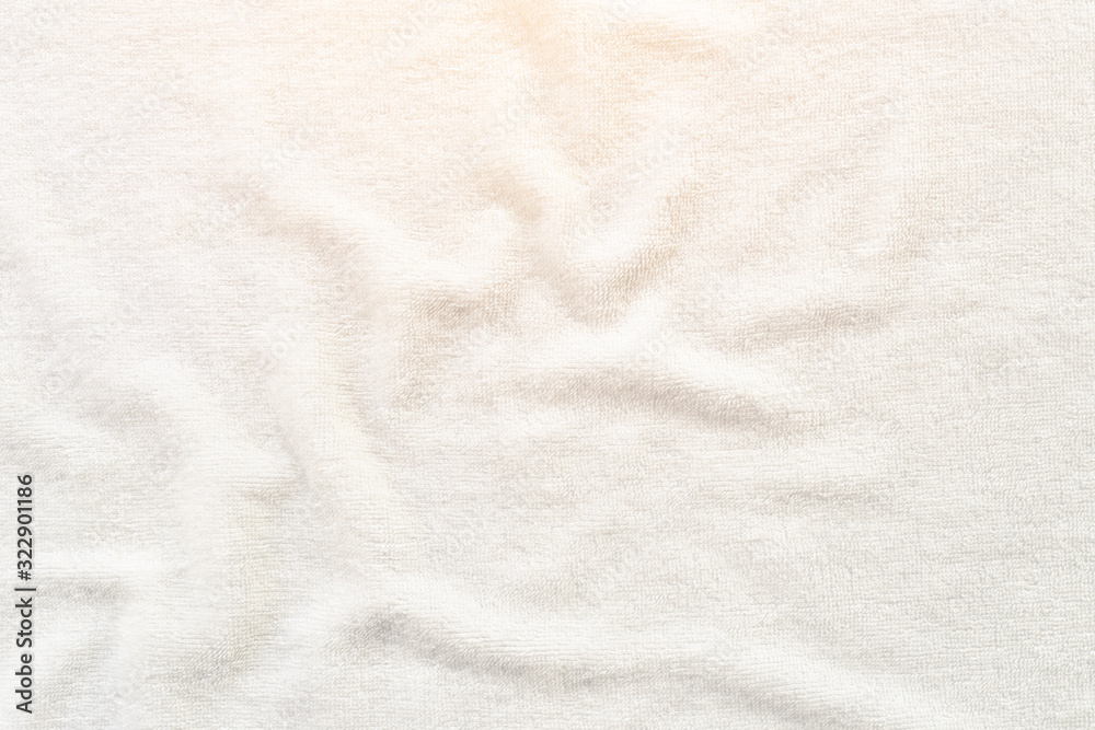 Naklejka premium White towel texture background with abstract pattern. That fabric or textile consist of cotton fiber or natural material. For absorb water, drying and wiping in bathroom, laundry and kitchen room.