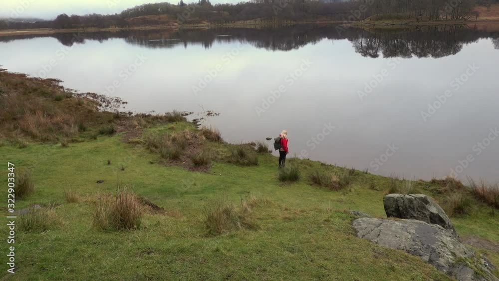 Girl in red coat looking across Loch Awe in Scotland Girl in red coat looking across Loch Awe in Scotland